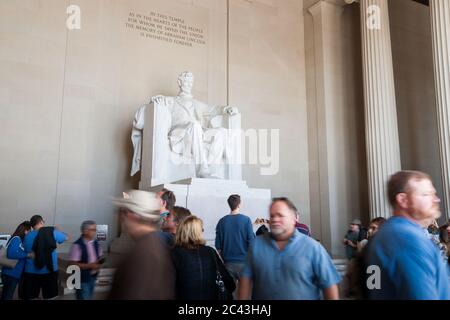 Washington DC USA - October 26 2014; Tourists blurred in motion below large white statue of Abraham Lincoln in Lincoln Memorial. Stock Photo
