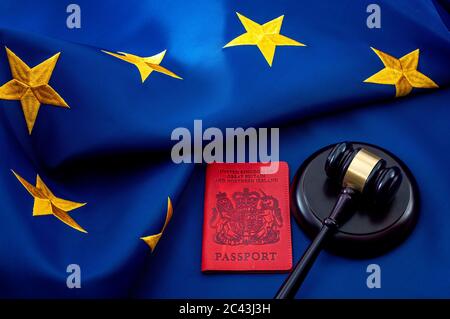 Immigration law, Brexit and United Kingdom citizens rights in Europe concept theme with UK passport and a wooden gavel against the EU flag Stock Photo