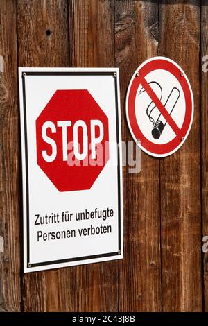 Stop sign and no smoking sign on a wooden fence, Engen, Baden-Württemberg, Germany Stock Photo