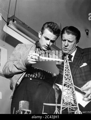 JAMES DEAN and Director GEORGE STEVENS on set candid during the filming of GIANT 1956 novel EDNA FERBER  George Stevens Productions / Warner Bros. Stock Photo