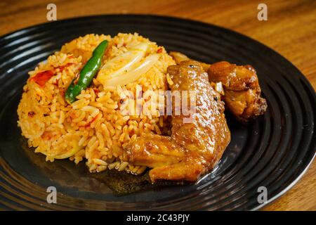 Spicy fried rice with grilled black pepper chicken wings. Stock Photo