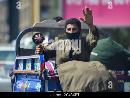 Cairo. 23rd June, 2020. A man wearing a face mask is seen on a motor tricycle in Cairo, Egypt on June 23, 2020. Egypt will reopen restaurants, cafes, and sports clubs from June 27 that were closed to curb the spread of coronavirus, Egyptian Prime Minister Mostafa Madbouly said on Tuesday. Credit: Wu Huiwo/Xinhua/Alamy Live News Stock Photo