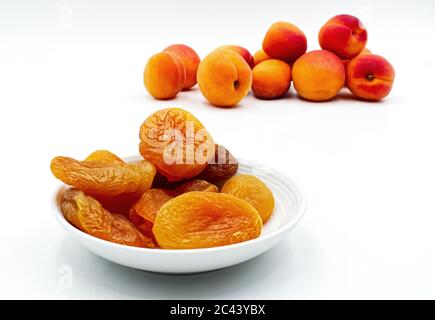 Dried apricots in a bowl isolated on white. Selective focus Stock Photo