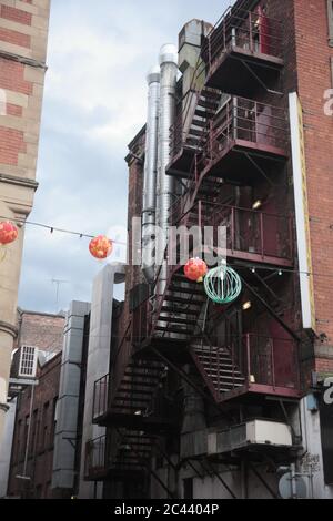 Fire escape in a back lane (St. James Street) in Chinatown, Manchester, England, UK Stock Photo