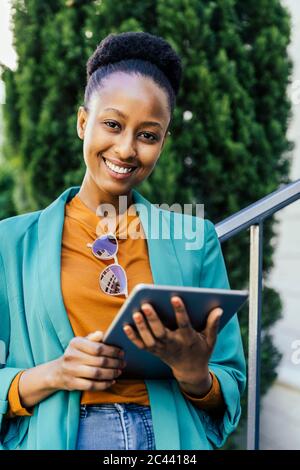 Portrait of young businesswoman with digital tablet outdoors Stock Photo