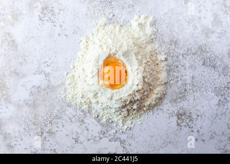 Close-up of egg yolk in flour Stock Photo
