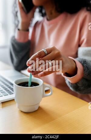 Close-up of young woman sitting at tablet working from home Stock Photo
