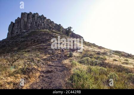Spain, Canary Islands, La Gomera, Low angle view of two hikers ascending Table Mountain Stock Photo