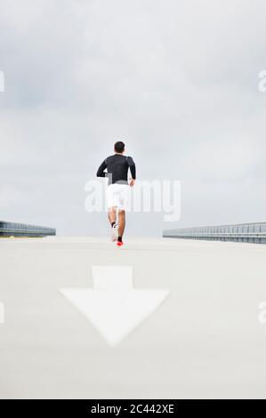 Young man running on a lane Stock Photo