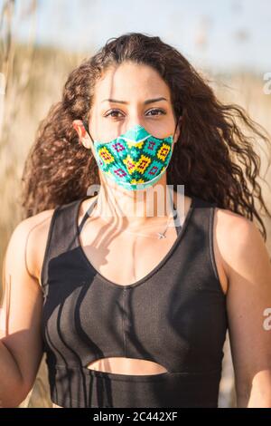 Portrait of young woman wearing self-sewn protective mask Stock Photo
