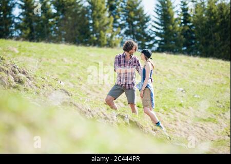 Hiking couple on meadow in summer, Wallberg, Bavaria, Germany