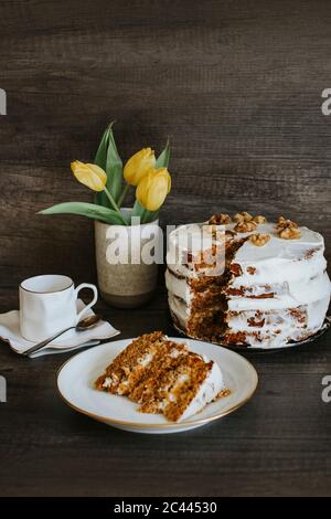 Homemade carrot cake, coffee and tulips Stock Photo