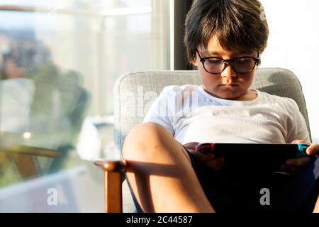 Boy playing video game on a games console Stock Photo