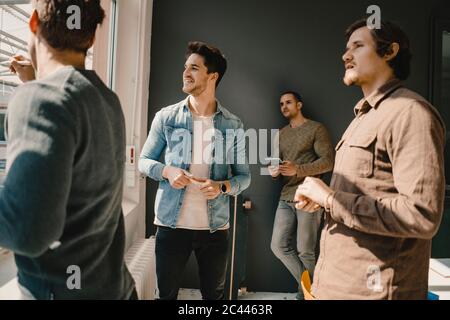 Young entrepreneurs having a meeting in their start up business Stock Photo