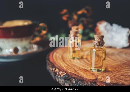 Wiccan witch altar, with mini bottles with oil in them that look like small potion bottles, or essence, essential oils, or any other yellow oil Stock Photo