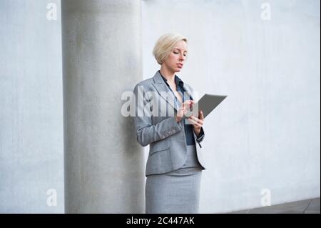 Portrait of blond businesswoman using tablet Stock Photo