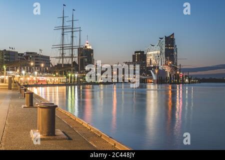 Germany, Hamburg, Bollards along Saint Pauli Piers with Rickmer Rickmers ship and Elbphilharmonie in background Stock Photo