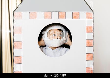 Girl playing astronaut in a rocket Stock Photo