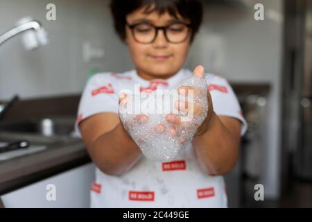 Boy with foam in his hands Stock Photo
