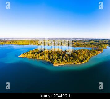 Germany, Bavaria, Inning am Ammersee, Drone view of clear sky over forested shore of Worth island Stock Photo