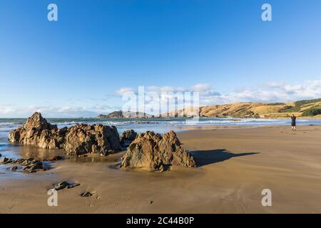 New Zealand, Rock formations on sandy coastal beach of Nugget Point Stock Photo