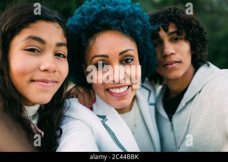Happy mother with children taking selfie in park Stock Photo
