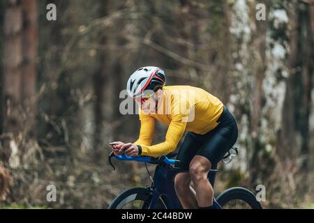 Young man in sports clothing riding bicycle Stock Photo