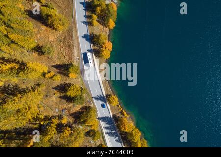 Switzerland, Canton of Grisons, Saint Moritz, Drone view of highway stretching along shore of Lake Sils in autumn Stock Photo