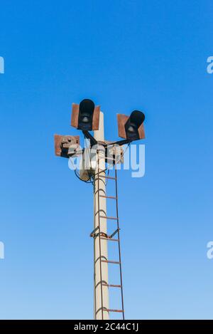 Rusty railroad lights and blue sky outdoors Stock Photo