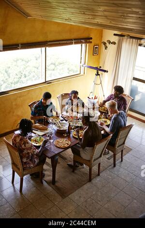 High angle view of friends eating lunch while sitting at dining table Stock Photo