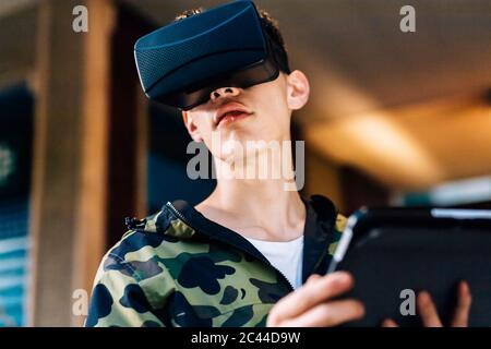 Man looking through virtual reality simulator in city Stock Photo