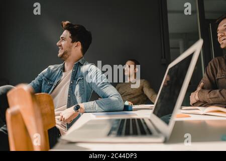 Young entrepreneurs having a meeting,  laptop on the table Stock Photo