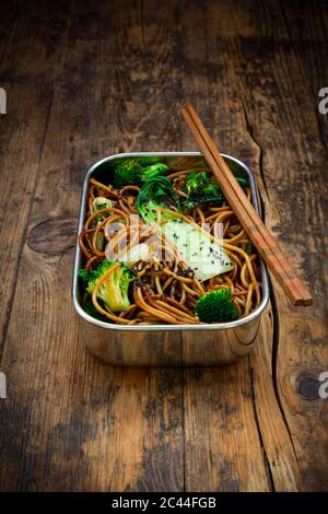Lunch box of soba noodles with bok choy, broccoli, soy sauce and black sesame seeds Stock Photo