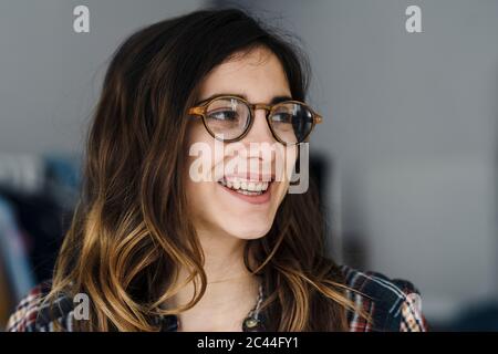 Portrait of laughing young woman wearing glasses Stock Photo