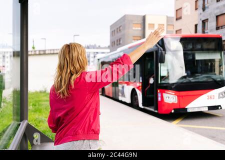 woman-stopping-bus-at-bus-stop