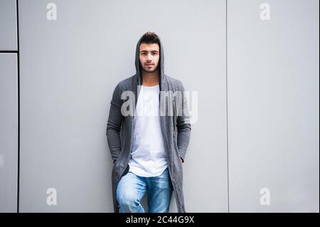 Fashionable young man standing against wall Stock Photo