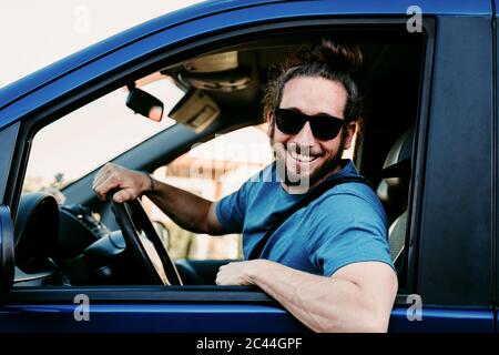 Portrait of happy man in car Stock Photo
