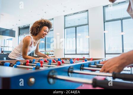 Young business people playing football in their lunch break Stock Photo