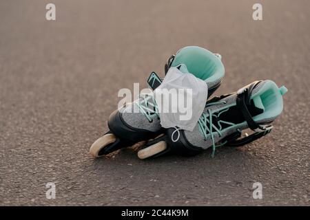 Close-up of face mask on inline skates on at skateboard park Stock Photo