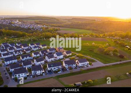Germany, Baden-Wurttemberg, Waiblingen, Aerial view of modern suburb at sunset Stock Photo