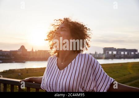 Portrait of smiling woman in the evening light Stock Photo