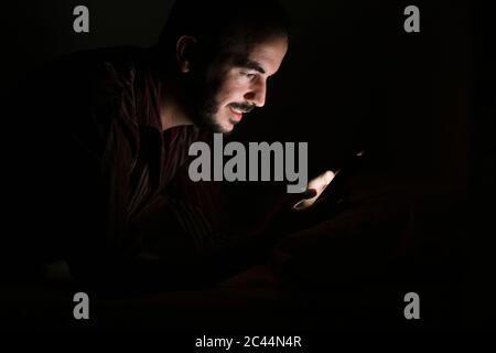Man using smartphone at night Stock Photo