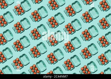 Pattern of chicken eggs in turquoise colored cartons Stock Photo