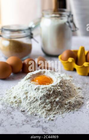 Close-up of egg yolk in flour Stock Photo
