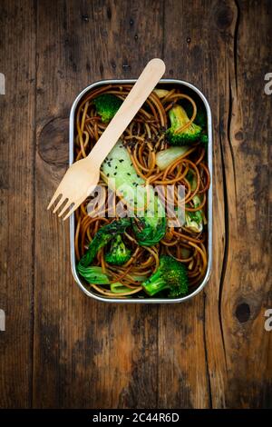 Lunch box of soba noodles with bok choy, broccoli, soy sauce and black sesame seeds Stock Photo