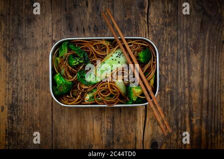 Lunch box of soba noodles with bok choy, broccoli, soy sauce and black sesame seeds Stock Photo