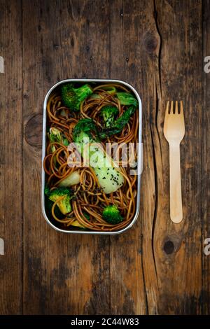 Lunch box of soba noodles with bok choy, broccoli, soy sauce and black sesame seeds Stock Photo