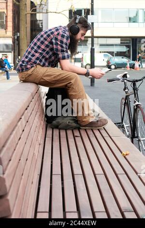 Bearded man reading newspaper in street Stock Photo - Alamy