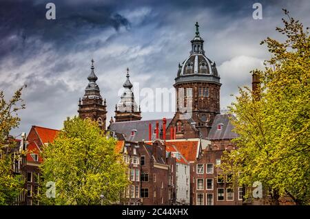 Netherlands, North Holland, Amsterdam, Old town houses in front of Basilica Of Saint Nicholas Stock Photo