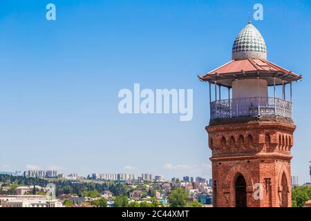 Minaret of Jumah Mosque against clear blue sky during sunny day, Tbilisi, Georgia Stock Photo